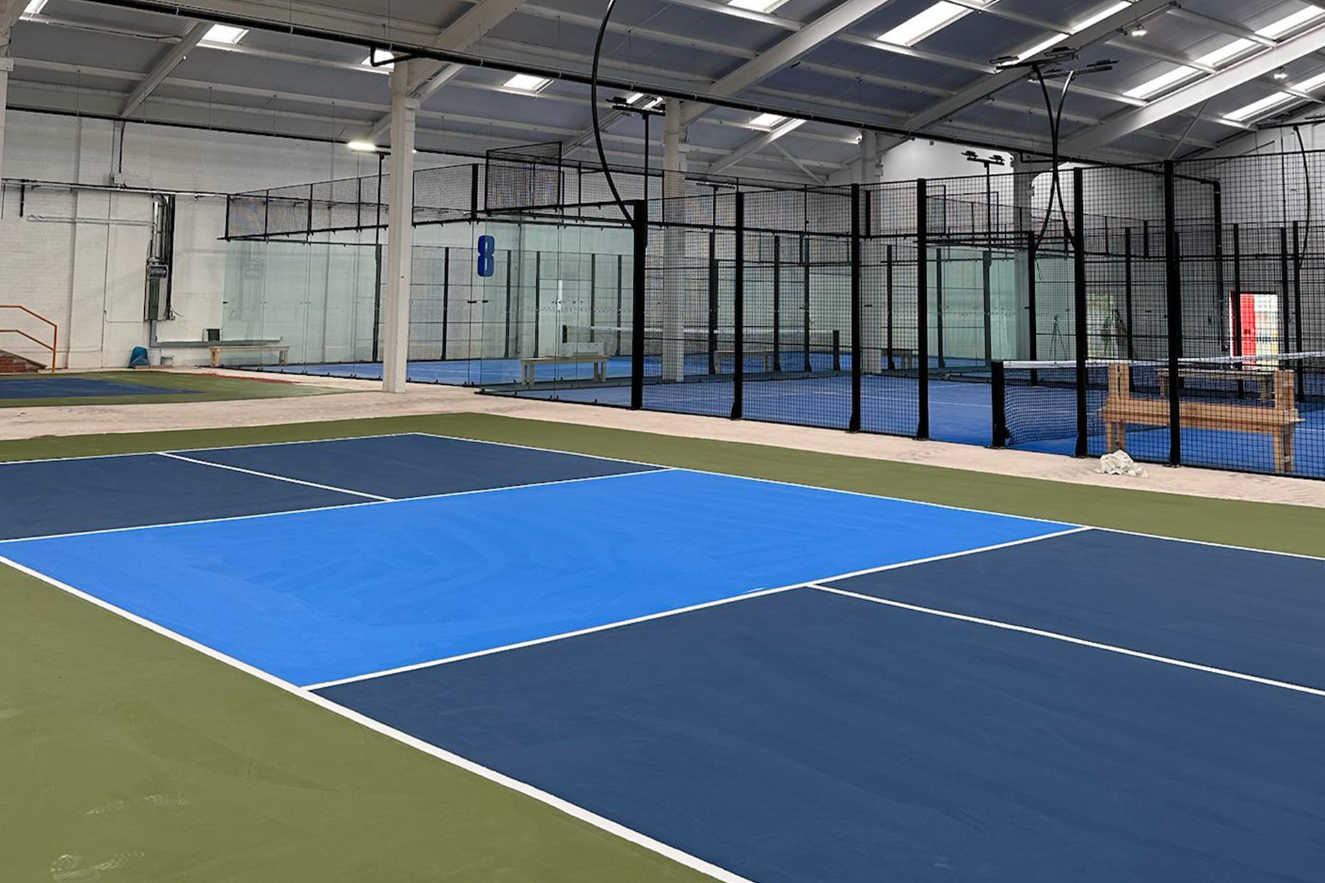 Indoor padel court with a dual-tone blue playing surface in Hull