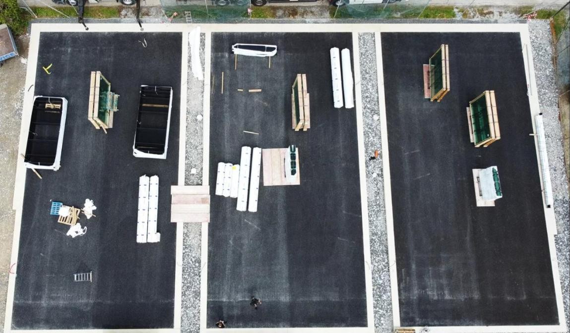 Padel court construction in the UK: three concrete bases prepared with drainage before the structures are installed